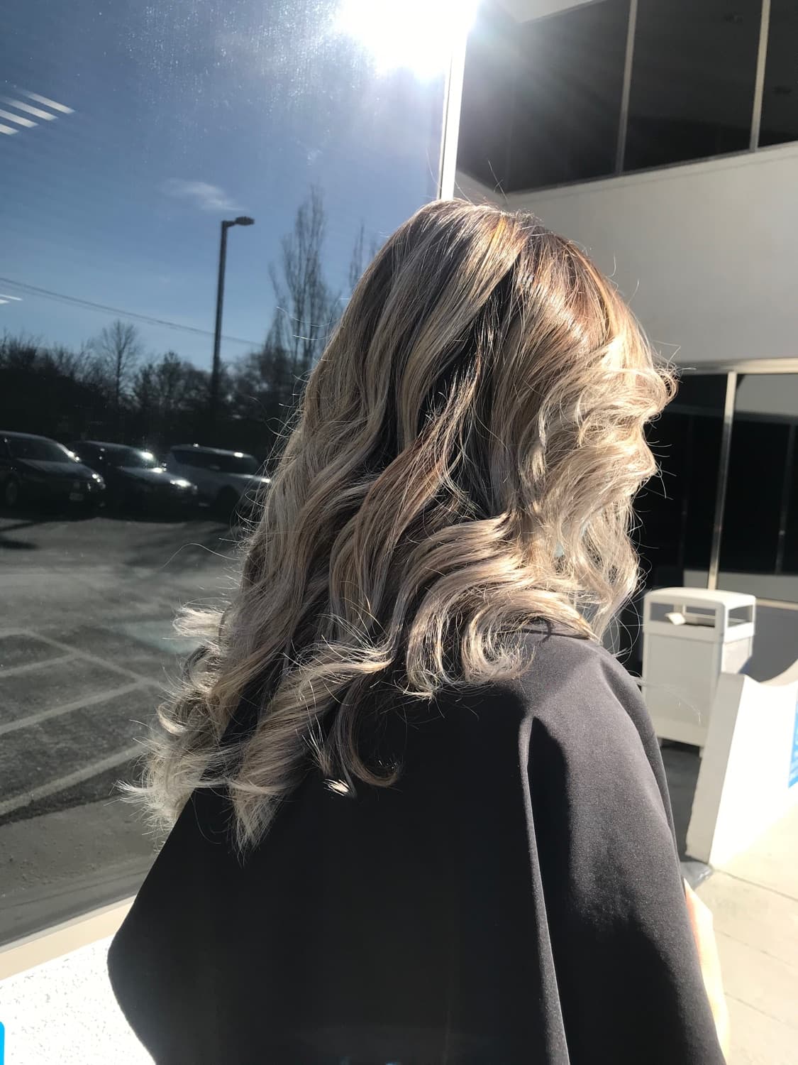 Long, full waves with colour-matched extensions blended into the client's own hair